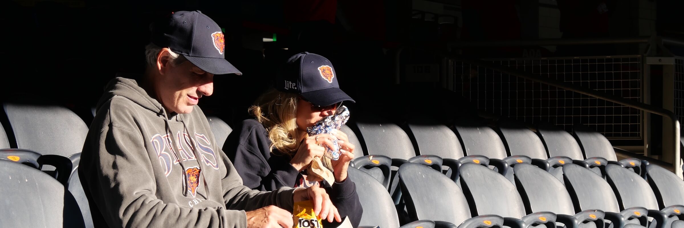 Fans eating concessions food at a stadium - Desktop