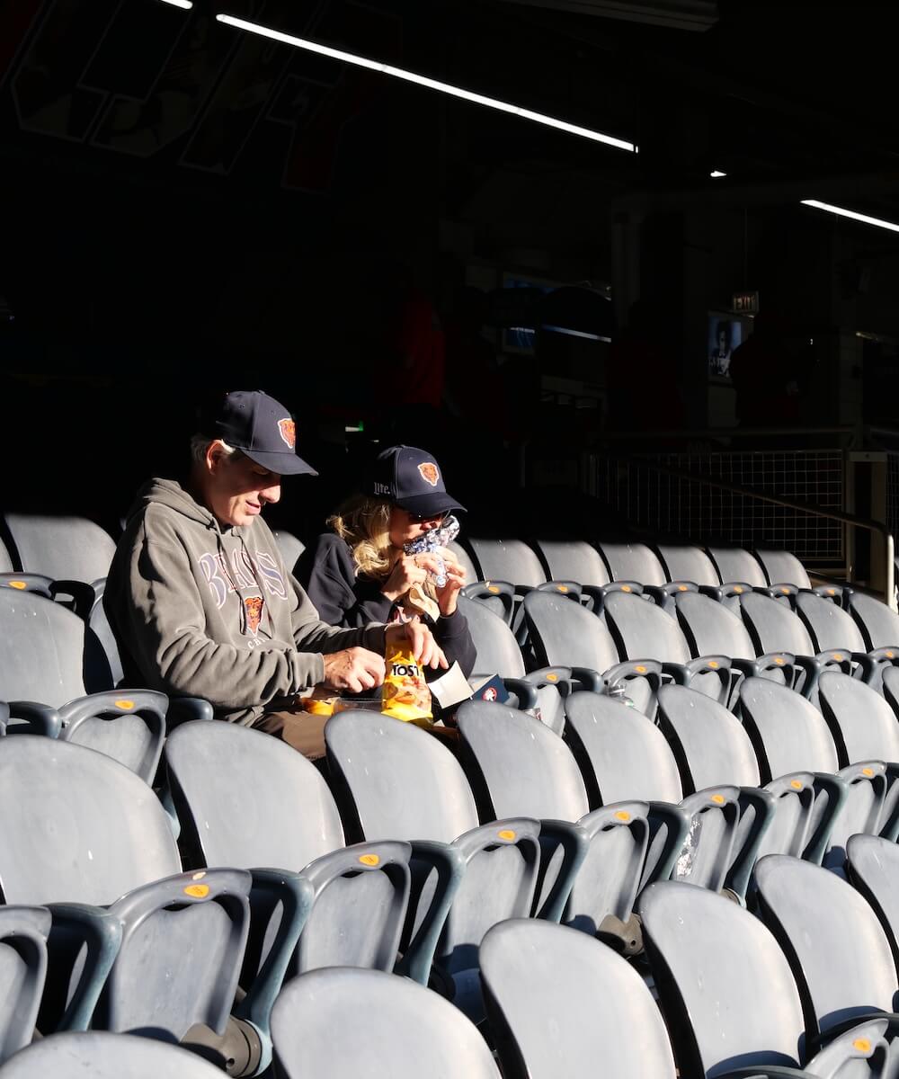 Fans eating concessions food at a stadium - Mobile